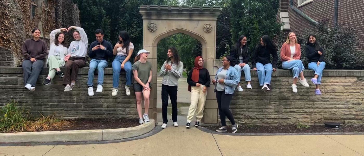 Peer educator team standing at the Edwards Arch, laughing